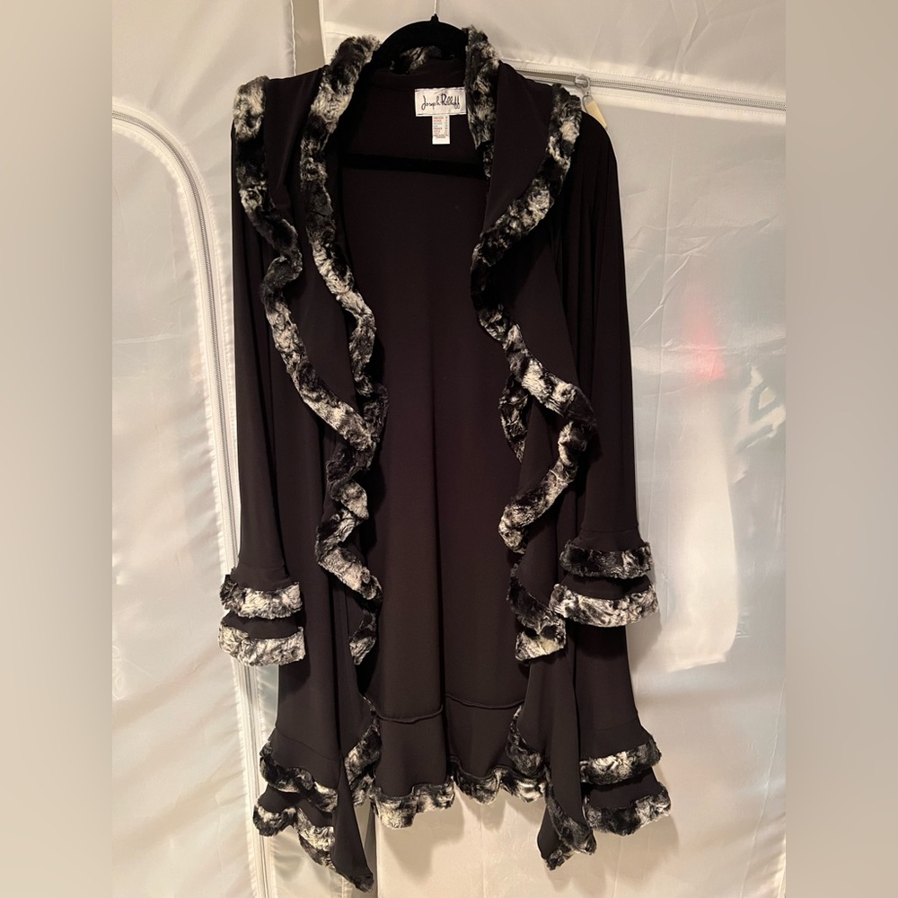 Evening jacket with fur trim.